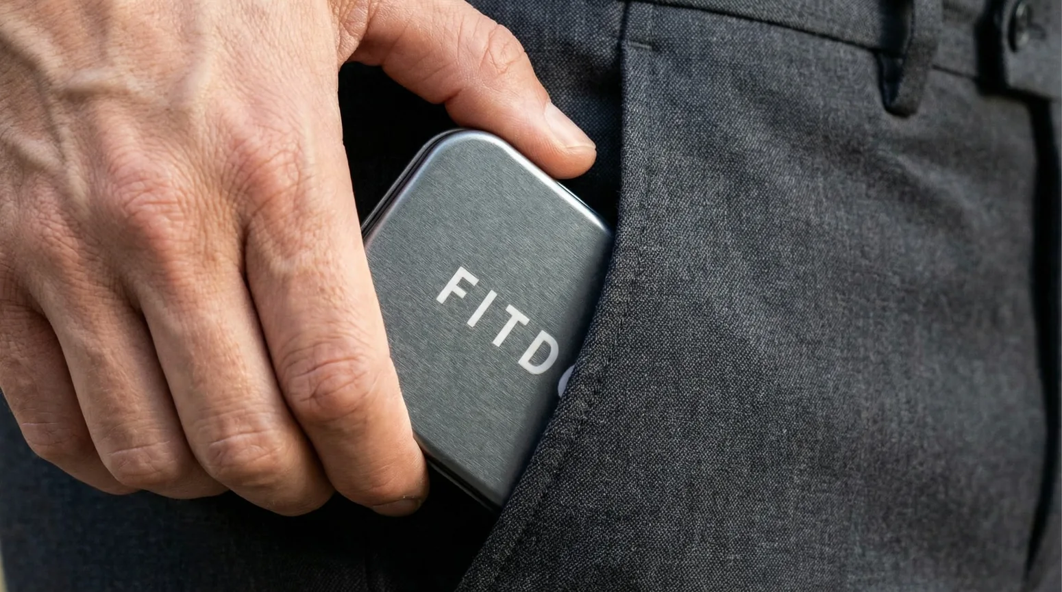 Persona guardando el pastillero FITDOSE en el bolsillo de un pantalón